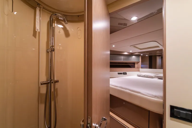  Yacht Photos Pics Luxurious interior of 2007 Riva Rivale 52 yacht featuring a bedroom and shower.
