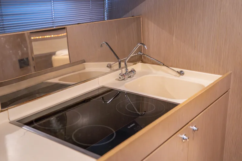  Yacht Photos Pics Modern kitchen area in a 2007 Riva Rivale 52 yacht with stove and sink.