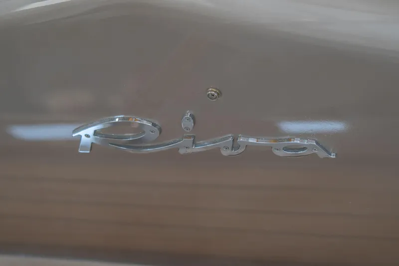  Yacht Photos Pics Riva Rivale 52, 2007 model, chrome logo on sleek boat surface.