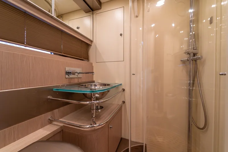  Yacht Photos Pics Luxurious bathroom interior of 2007 Riva Rivale 52 yacht with modern fixtures.