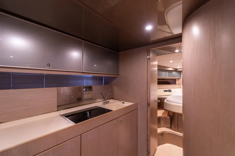  Yacht Photos Pics Luxurious interior of 2007 Riva Rivale 52 yacht with modern kitchen and sleek design.