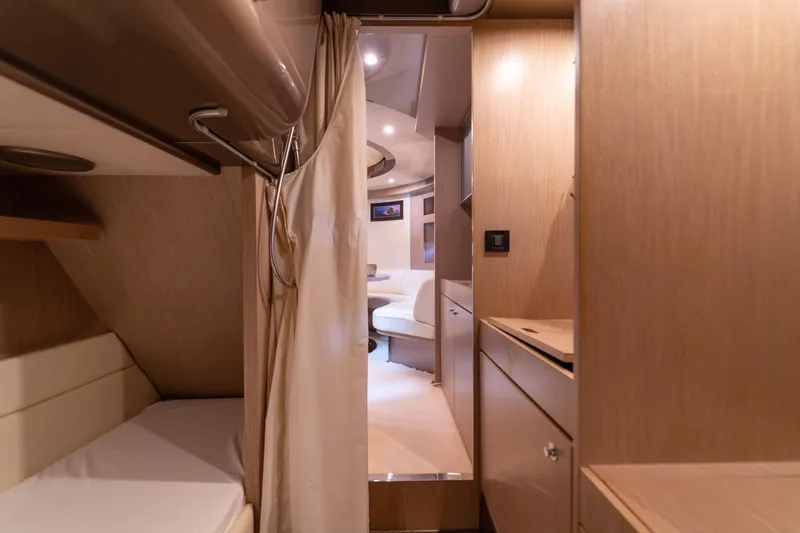  Yacht Photos Pics Interior of a 2007 Riva Rivale 52 yacht, featuring cozy wooden cabin design.