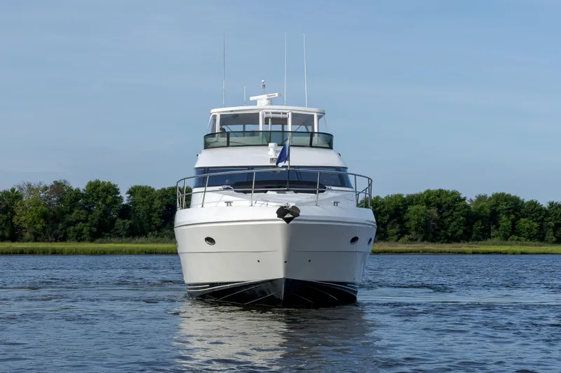  Yacht Photos Pics Front view of 2004 Neptunus 56 Flybridge yacht on calm water.
