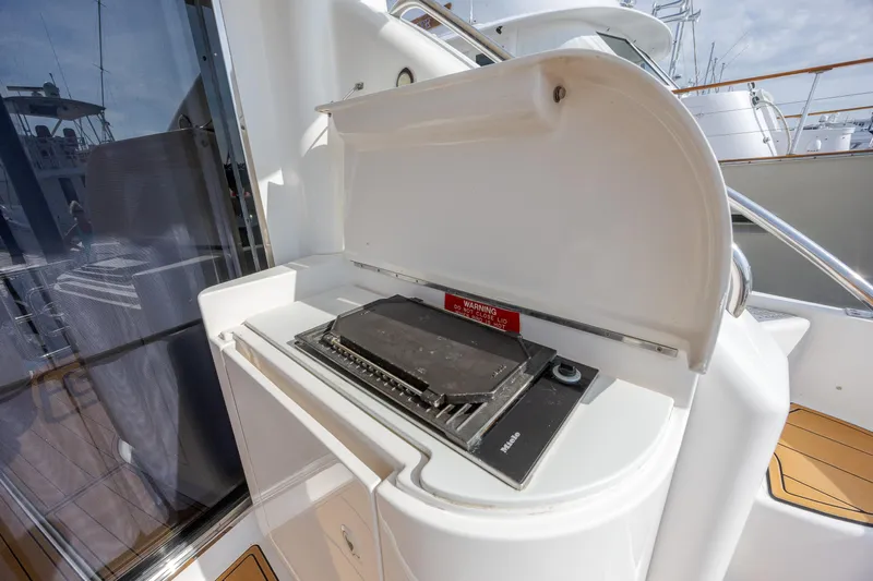  Yacht Photos Pics Outdoor grill on 2004 Neptunus 56 Flybridge yacht, featuring sleek design and modern amenities.