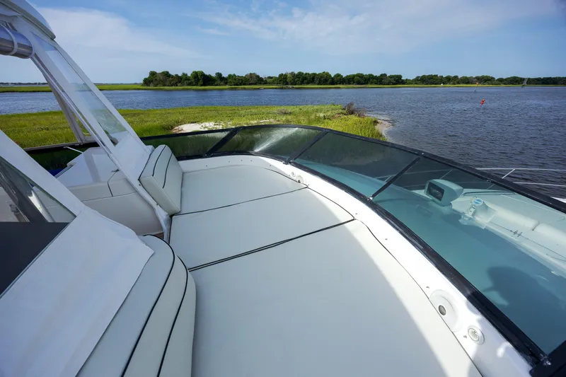  Yacht Photos Pics Luxurious 2004 Neptunus 56 Flybridge yacht with spacious deck overlooking serene waters.