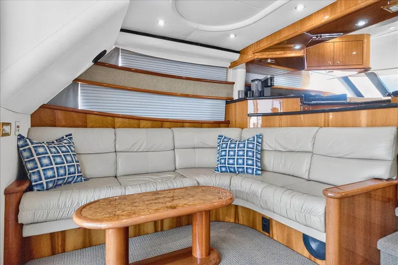  Yacht Photos Pics Luxurious 2004 Neptunus 56 Flybridge yacht interior with plush seating and elegant wood finishes.