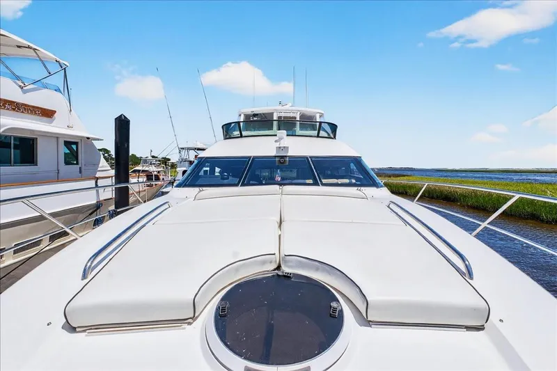  Yacht Photos Pics 2004 Neptunus 56 Flybridge yacht docked, showcasing sleek design and spacious deck.