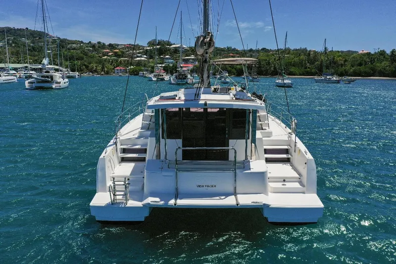 Viewfinder Yacht Photos Pics 2020 Bali 4.1 catamaran anchored in a scenic bay with other boats.
