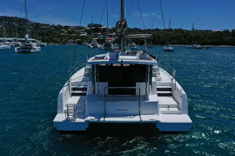 Viewfinder Yacht Photos Pics Bali 4.1 catamaran, 2020 model, anchored in a scenic bay with other boats.