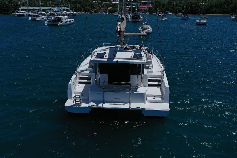 Viewfinder Yacht Photos Pics 2020 Bali 4.1 catamaran anchored in a serene harbor with other boats.