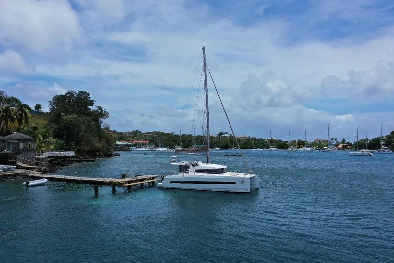 Viewfinder Yacht Photos Pics Sailboat Bali 4.1 (2020) docked in a serene marina with lush greenery.