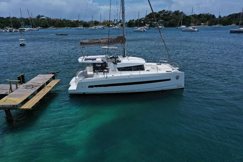 Viewfinder Yacht Photos Pics Catamaran Bali 4.1, 2020 model, docked in a serene marina with clear blue waters.