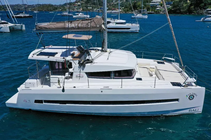 Viewfinder Yacht Photos Pics Bali 4.1 catamaran, 2020 model, anchored in a serene bay with other boats.