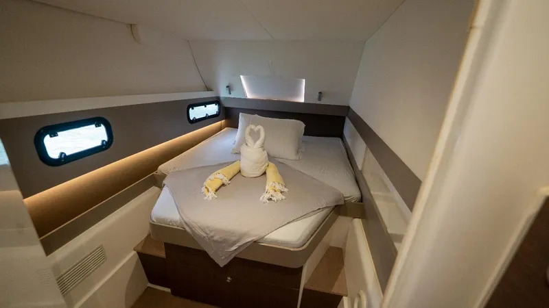 Viewfinder Yacht Photos Pics Cozy cabin interior of 2020 Bali 4.1 yacht with elegant bedding and towel swan.