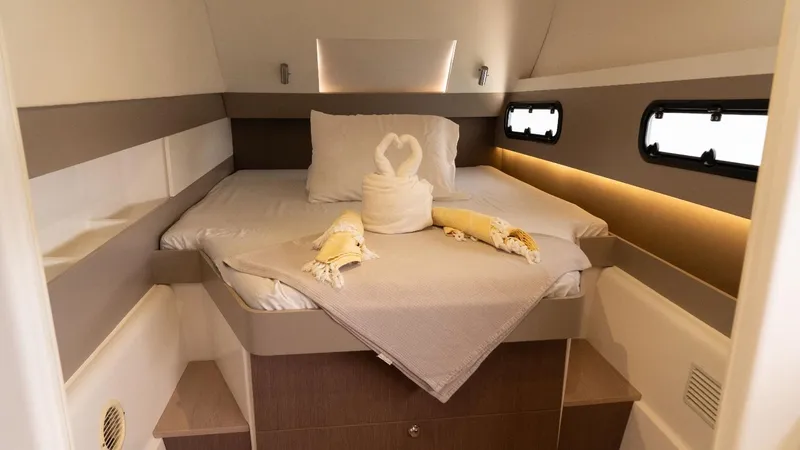 Viewfinder Yacht Photos Pics Cozy cabin interior of 2020 Bali 4.1 yacht with elegant bedding and soft lighting.