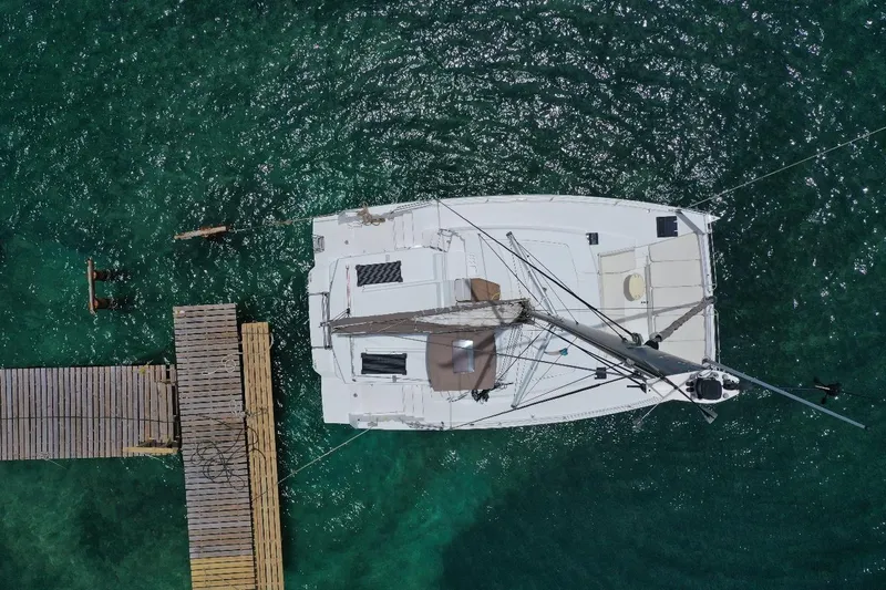 Viewfinder Yacht Photos Pics Aerial view of Bali 4.1 catamaran docked on clear turquoise water, 2020 model.