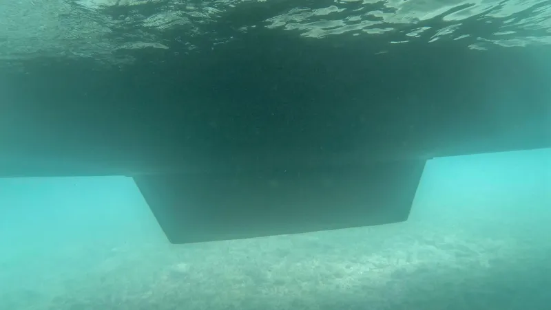 Viewfinder Yacht Photos Pics Underwater view of a 2020 Bali 4.1 catamaran hull in clear blue water.