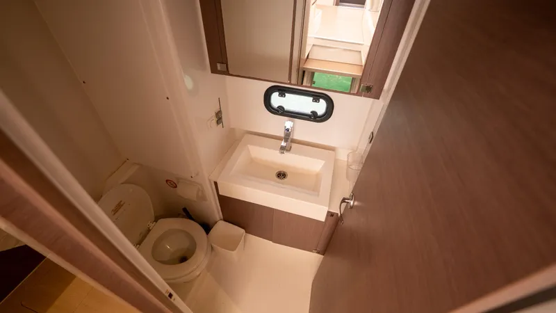 Viewfinder Yacht Photos Pics Compact bathroom in a 2020 Bali 4.1 model, featuring a sink, toilet, and mirror.