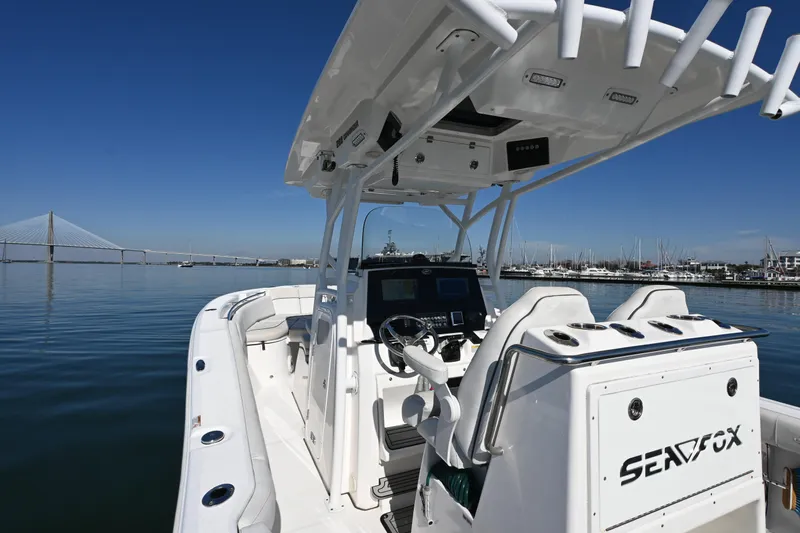  Yacht Photos Pics 2020 Sea Fox 288 Commander boat on calm water with bridge and marina background.
