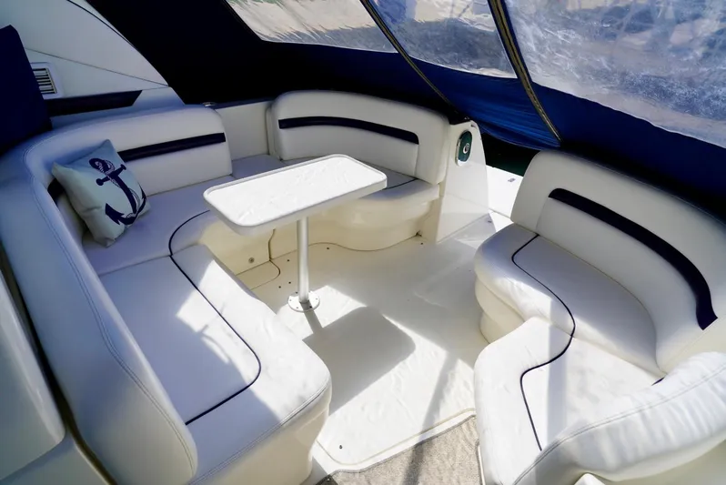  Yacht Photos Pics Luxurious interior of 2010 Sea Ray 390 Sundancer yacht with white seating and table.