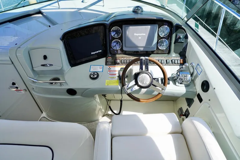  Yacht Photos Pics Helm of 2010 Sea Ray 390 Sundancer with modern navigation equipment and comfortable seating.