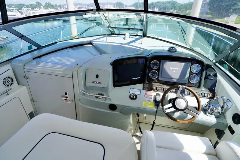  Yacht Photos Pics 2010 Sea Ray 390 Sundancer helm with modern navigation equipment and comfortable seating.