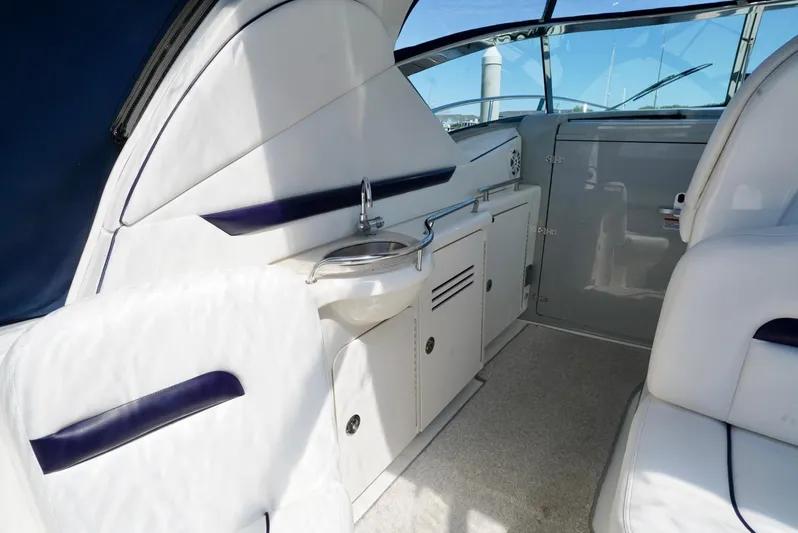  Yacht Photos Pics Interior view of 2010 Sea Ray 390 Sundancer yacht, featuring sleek white seating and compact kitchenette.