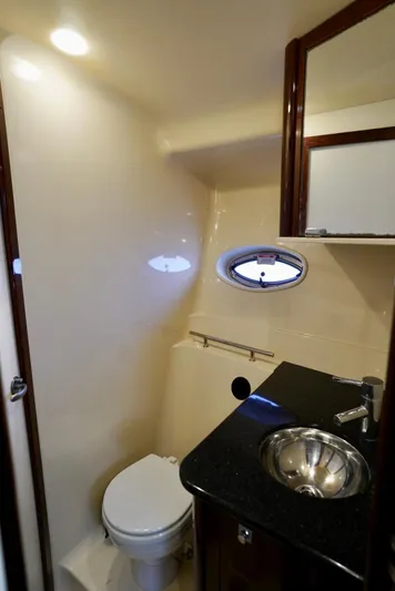  Yacht Photos Pics 2010 Sea Ray 390 Sundancer bathroom with sink, toilet, and porthole window.