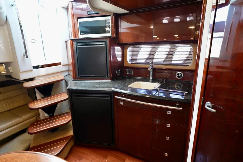  Yacht Photos Pics Luxurious kitchen interior of 2010 Sea Ray 390 Sundancer yacht with wood finish.