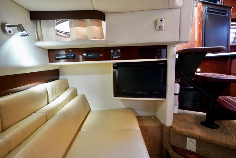  Yacht Photos Pics Interior of 2010 Sea Ray 390 Sundancer with beige seating and built-in TV.
