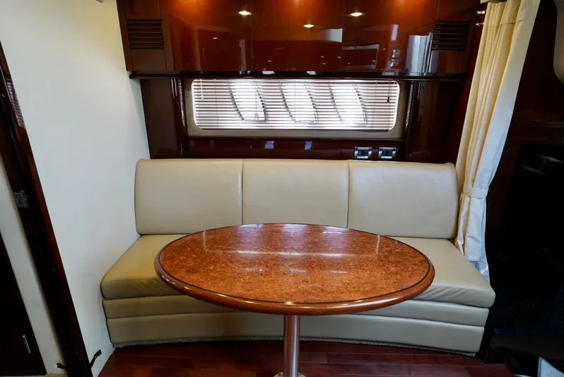  Yacht Photos Pics Interior of 2010 Sea Ray 390 Sundancer with beige seating and wooden table.