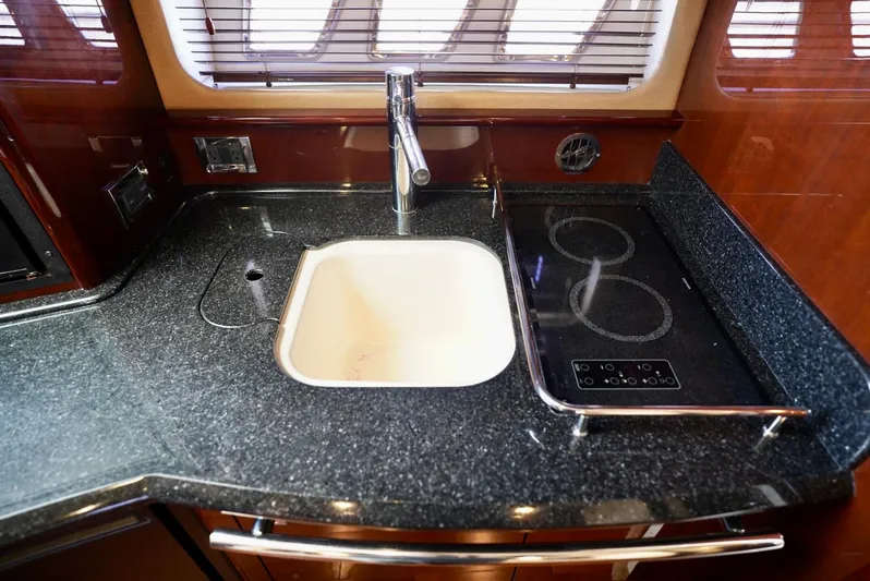  Yacht Photos Pics Luxurious kitchen area in 2010 Sea Ray 390 Sundancer yacht with sink and stove.