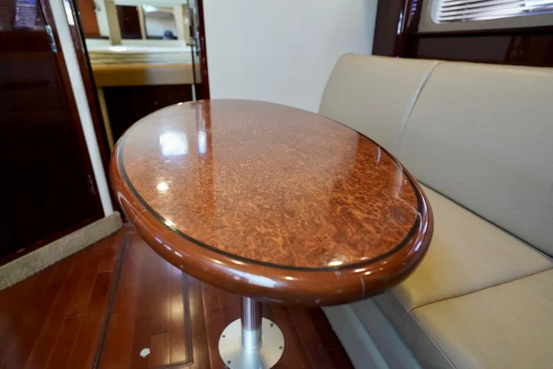  Yacht Photos Pics Luxurious interior of 2010 Sea Ray 390 Sundancer with elegant wooden table and seating.