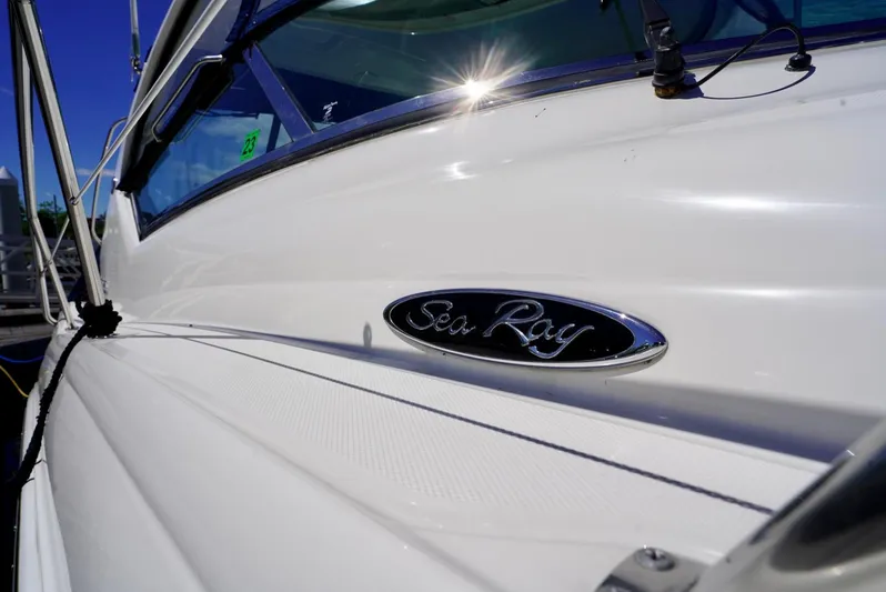  Yacht Photos Pics Sea Ray 390 Sundancer 2010 boat, close-up of logo and sleek white exterior.