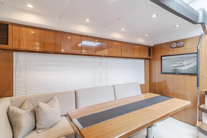 Release Me Yacht Photos Pics Luxurious interior of 2013 Princess V52 yacht with wooden finishes and comfortable seating.