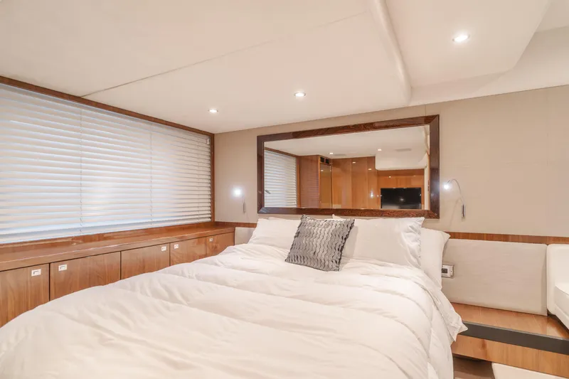 Release Me Yacht Photos Pics Luxurious bedroom interior of 2013 Princess V52 yacht with modern decor and ambient lighting.