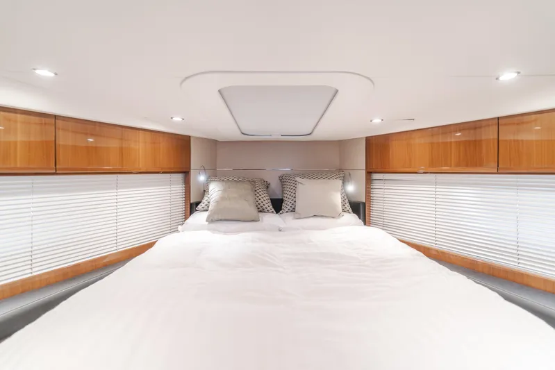 Release Me Yacht Photos Pics Luxurious bedroom interior of 2013 Princess V52 yacht with elegant wood cabinetry.