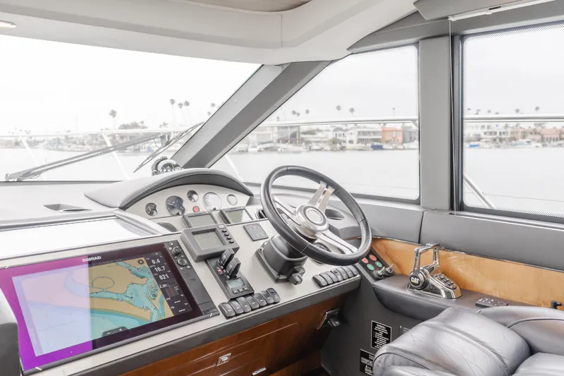 Release Me Yacht Photos Pics Cockpit of 2013 Princess V52 yacht with navigation equipment and steering wheel.