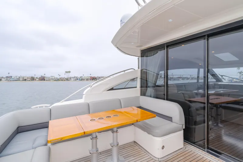 Release Me Yacht Photos Pics Luxury yacht Princess V52 2013 with elegant outdoor seating and ocean view.