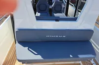 2023 Nimbus Commuter 8 boat interior with cushioned seating and wooden deck.