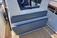 2023 Nimbus Commuter 8 boat interior with blue seating and wood flooring.