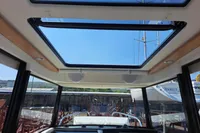 Interior view of 2023 Nimbus Commuter 8 boat with panoramic sunroof and modern design.
