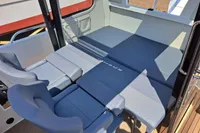 2023 Nimbus Commuter 8 interior seating area with blue cushions and modern design.