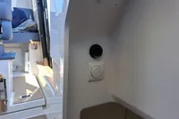 Interior of 2023 Nimbus Commuter 8 boat, featuring control panel and seating area.