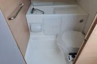 Compact bathroom in 2023 Nimbus Commuter 8 with toilet and sink.