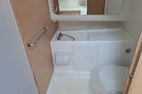 Compact bathroom in 2023 Nimbus Commuter 8 boat with toilet and sink.
