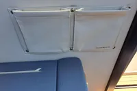 Interior of 2023 Nimbus Commuter 8 with fabric storage pockets and blue seating.