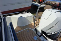 2023 Nimbus Commuter 8 boat with Mercury engine, featuring sleek deck design.