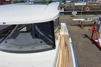 2023 Nimbus Commuter 8 boat docked, showcasing sleek design and wooden deck details.