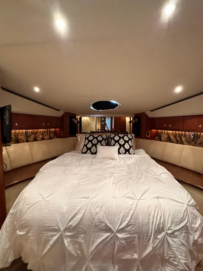  Yacht Photos Pics Luxurious bedroom interior of 1999 Cruisers 5000 Sedan Sport yacht with elegant bedding.